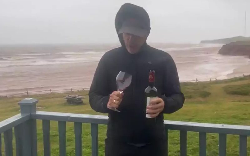 Sven Meier, tentando servir uma taça de vinho durante o furacão Fiona